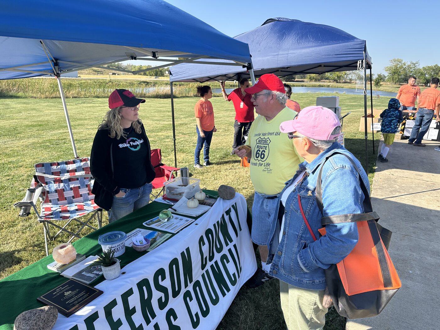 Jefferson County Trails Council volunteers talking with community members at an outreach booth