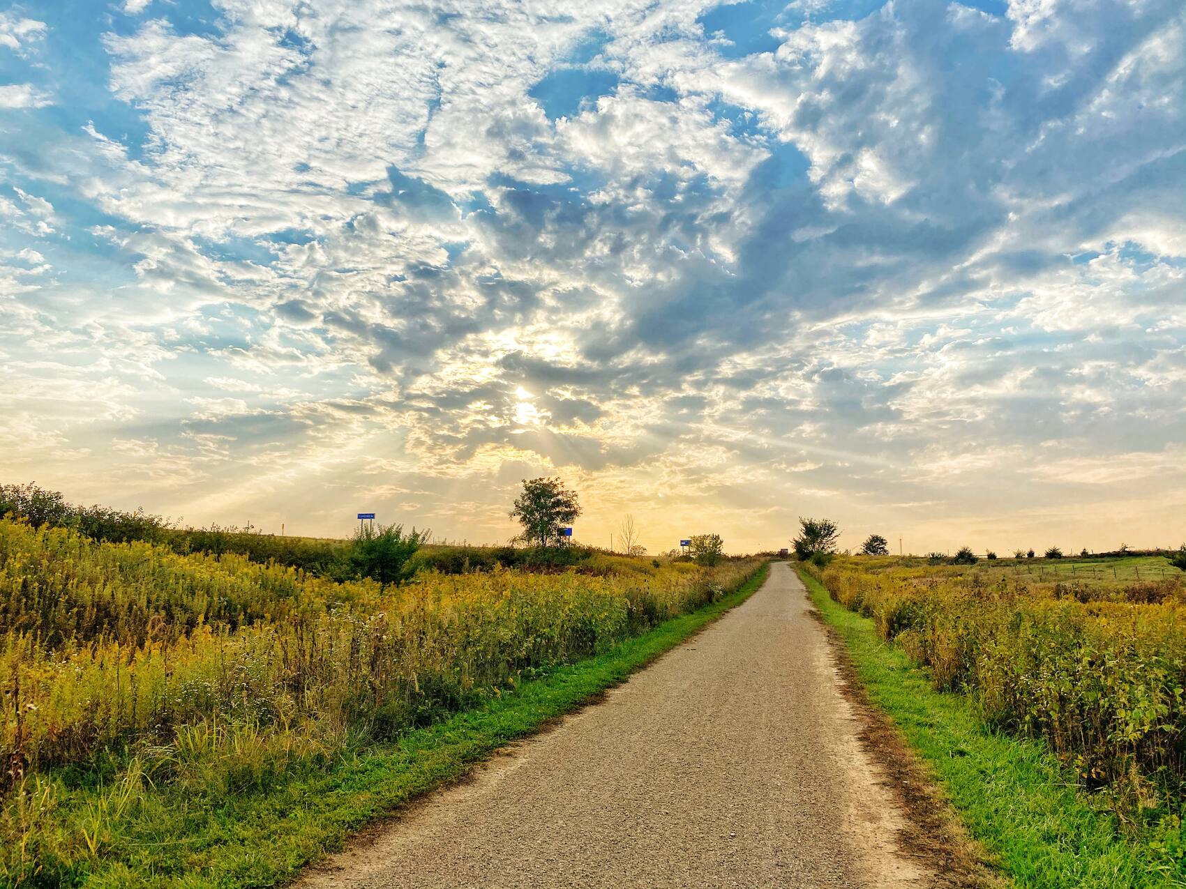 The trail cutting through open prairie under a wide sky